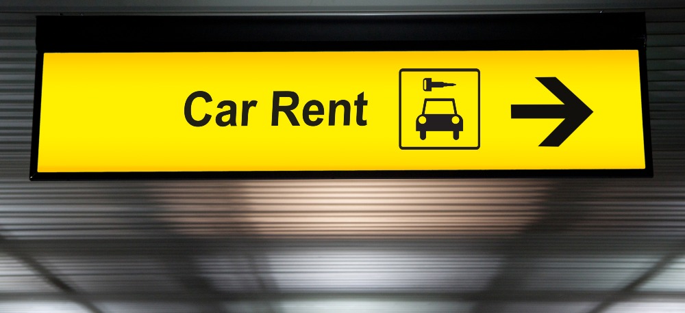 Airport sign pointing to car rental area