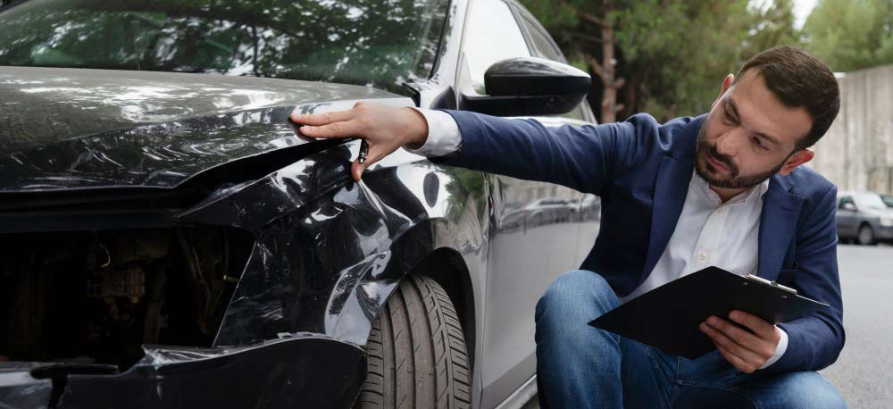 Man Inspecting Car Damage After A Collision