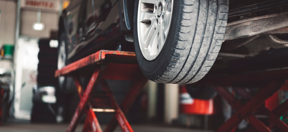 Car being inspected for damage that may void a warranty after an accident.